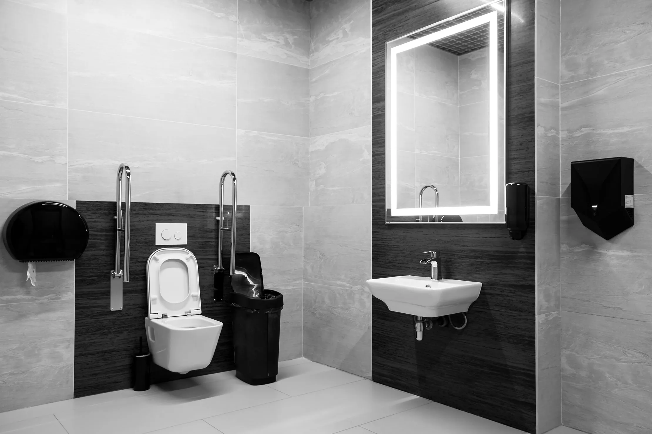 A black and white photo of a bathroom.